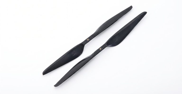 Two black drone propellers with matte finish
