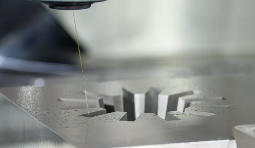 Sinker EDM machine burning a cavity in tool steel block