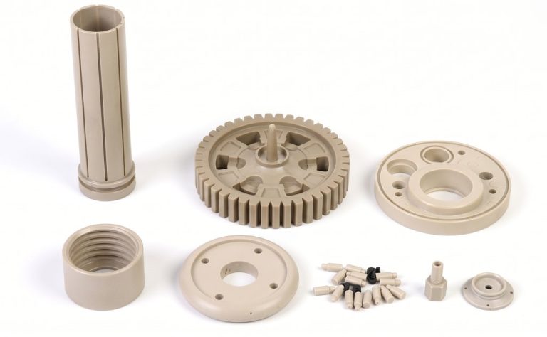 Assorted beige PEEK machined parts on white background