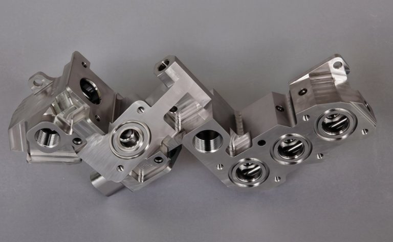 Precision machined aluminum part with multiple bores and threaded holes