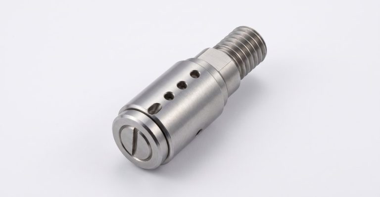 Metal nozzle with threaded end and precision holes