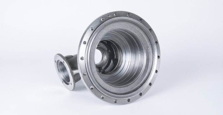 Machined metal reducer housing with flange and internal threads