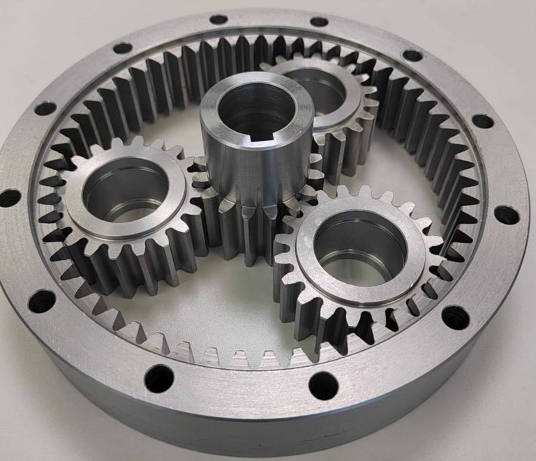 Custom machined gear shaft with spur gears on dark worktable