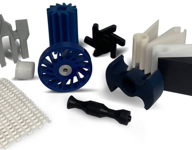 Assorted plastic machined parts on white background