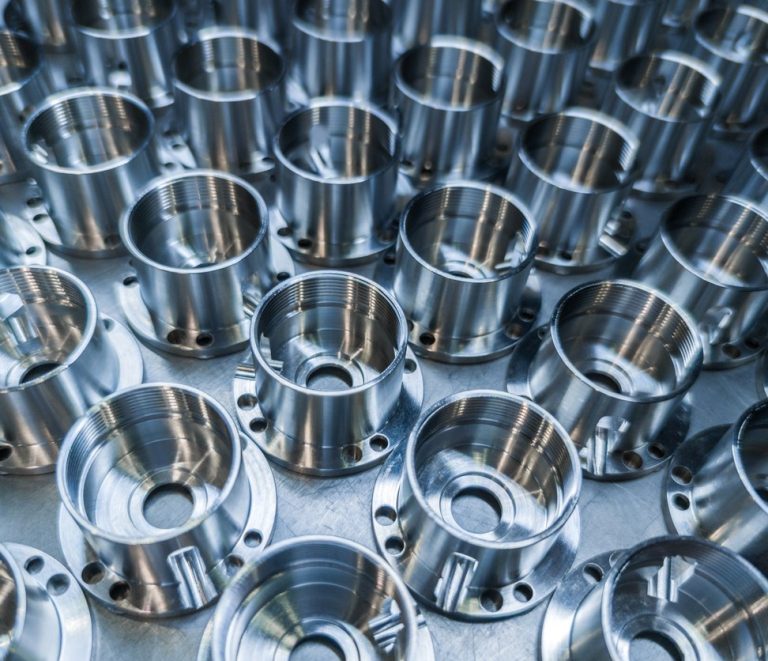 Batch of identical machined plates showing high volume CNC machining consistency