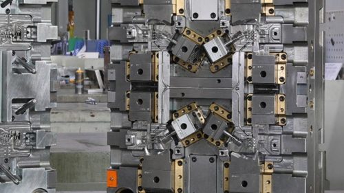 In-mold labeling injection mold with machined steel inserts and small parts