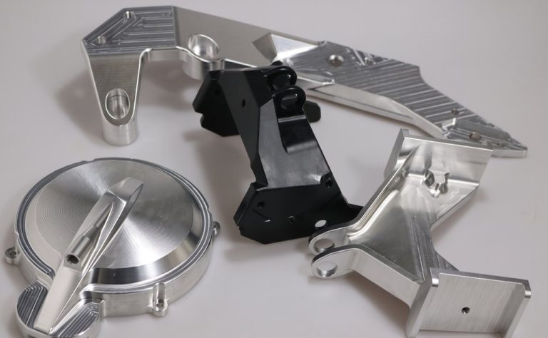 Machined aluminum parts with brushed and anodized finishes