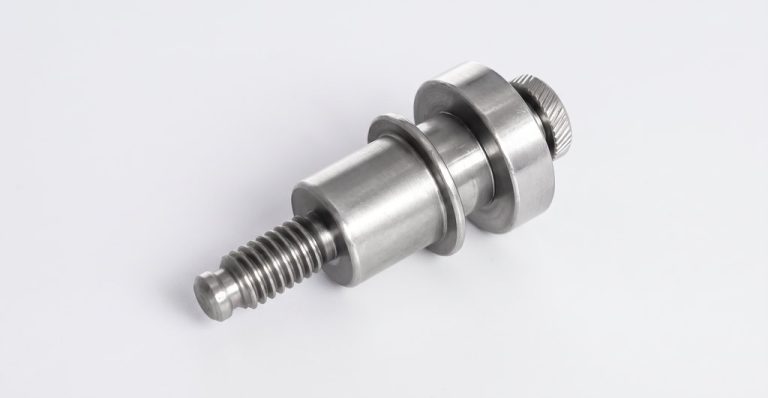 Metal machined part with threaded shaft and knurled head