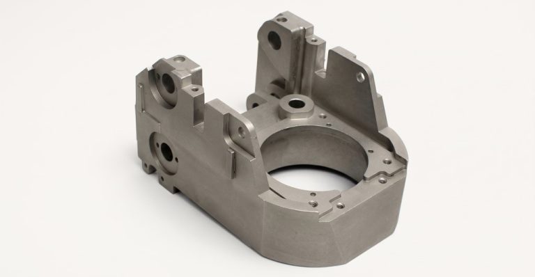 Machined steel housing with precision holes and mounting features