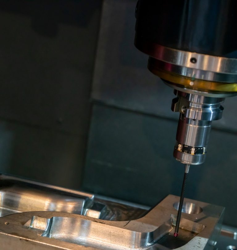 Vertical CNC milling spindle machining an aluminum workpiece