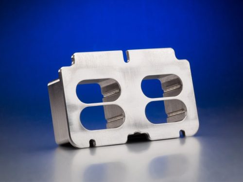Metal machined bracket with cutouts on blue background