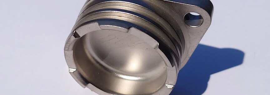 Machined magnesium housing part on white background