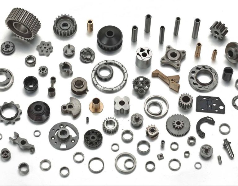 Assortment of machined metal parts on white background
