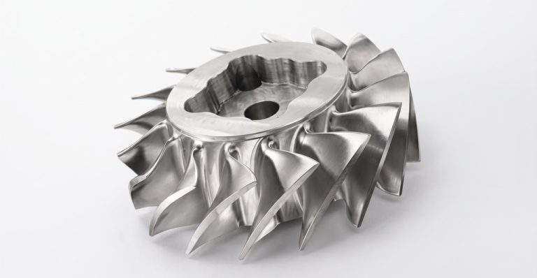 Machined metal impeller with curved blades and central hub