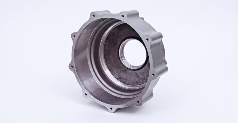 CNC machined metal housing with bolt holes and internal bore