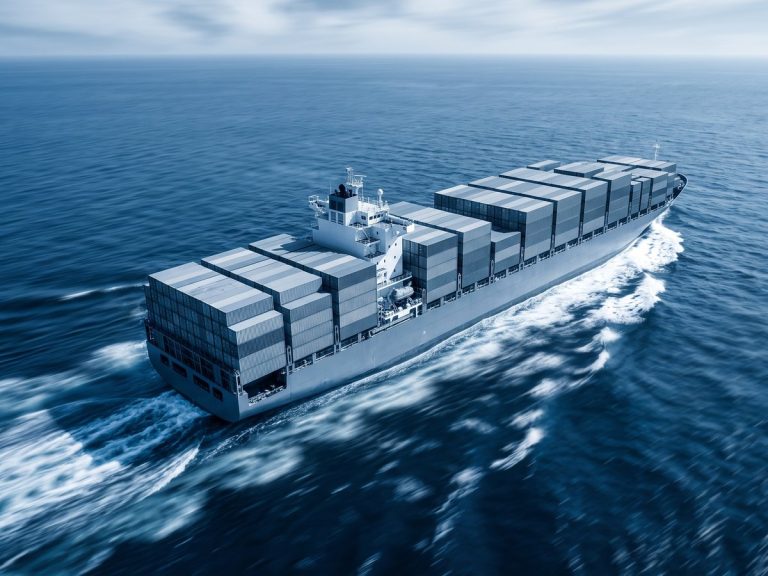 Marine industry: a large modern container ship ploughing through deep blue ocean waves
