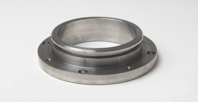Machined metal flange with bolt holes and smooth finish
