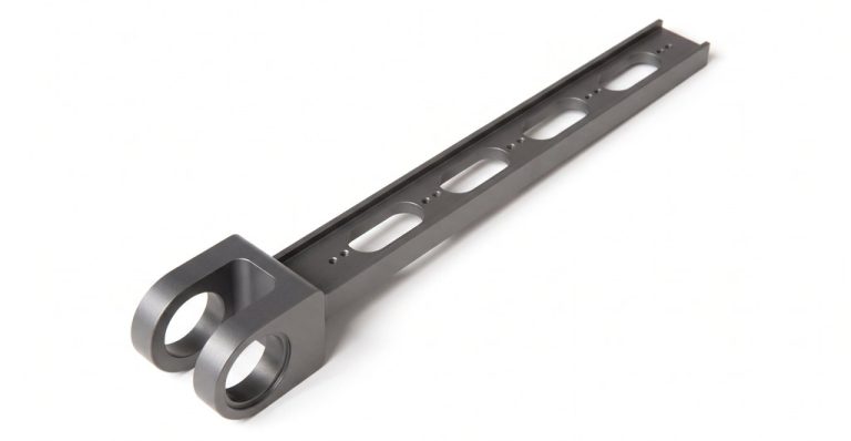 Black machined metal rail guide with precision cutouts
