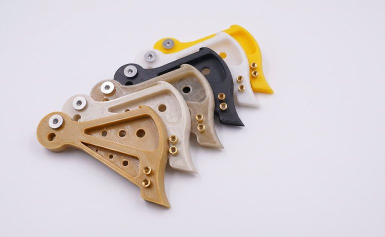 CNC machined plastic brackets in six labeled materials