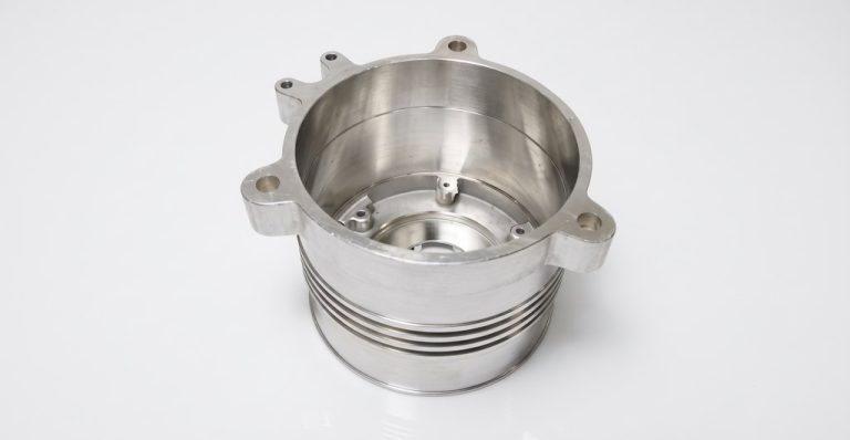 Precision machined metal housing with mounting flanges