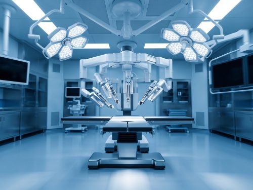 Medical industry: an empty modern hybrid operating room with a multi-arm surgical robot positioned over the operating table