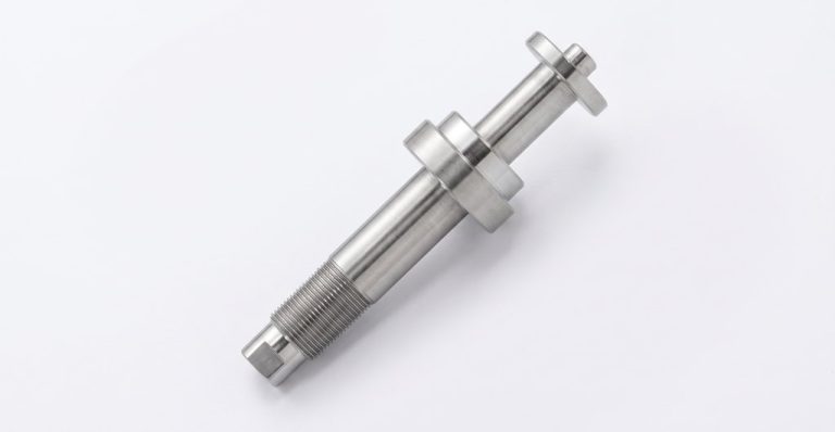 Precision machined medical component with threaded and polished sections