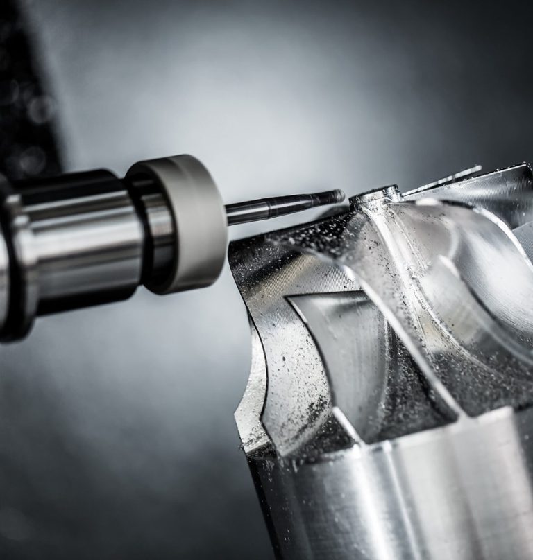 5-axis CNC milling tool cutting a curved aluminum surface