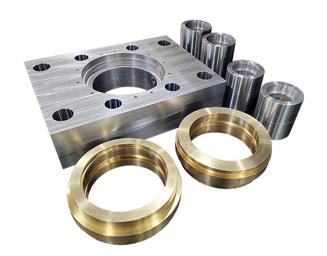 Machined steel and brass parts on white background