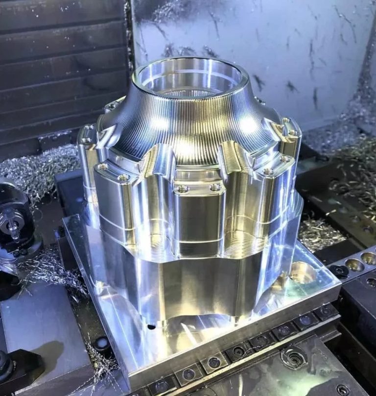 Large aluminum part on a CNC machine table after milling