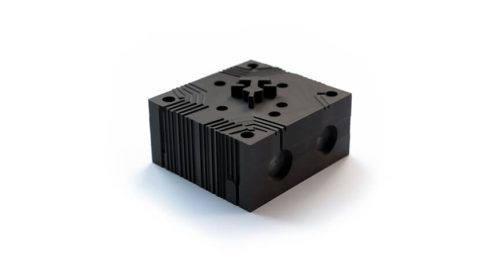 Black machined nylon block with holes and ribs