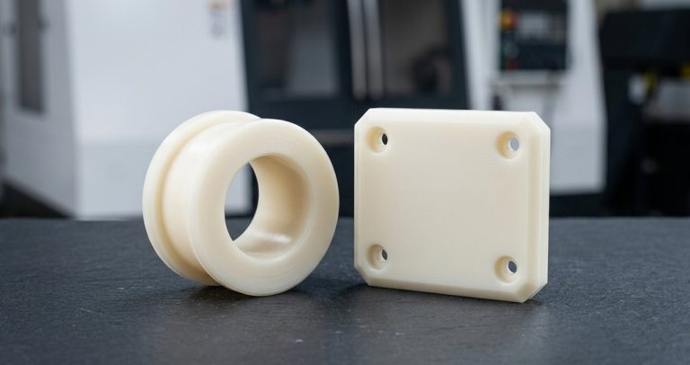 Finished nylon bushing and wear pad on worktable