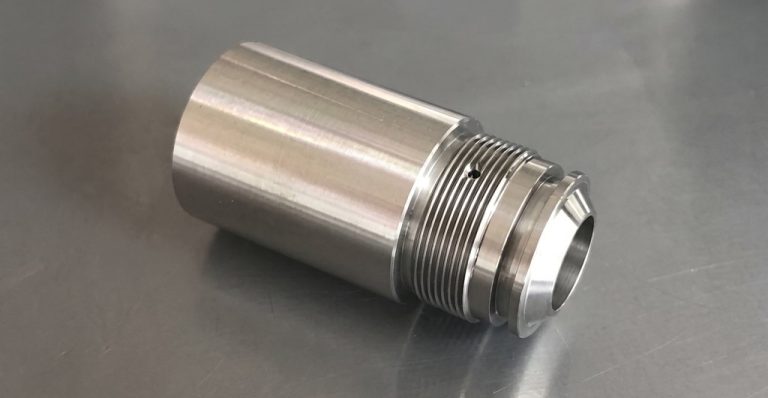 Precision machined metal part with threaded flange and polished finish