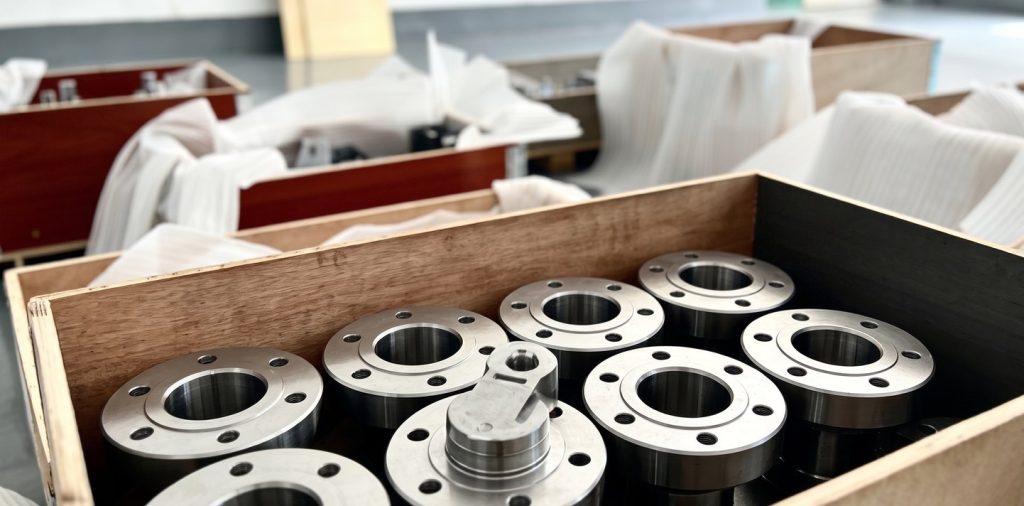 Machined stainless flanges packed in wooden crates for delivery
