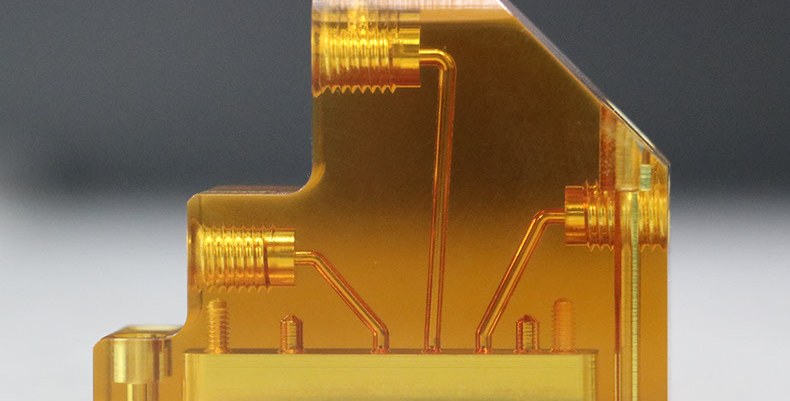 Transparent amber plastic part with internal microchannels and threaded features