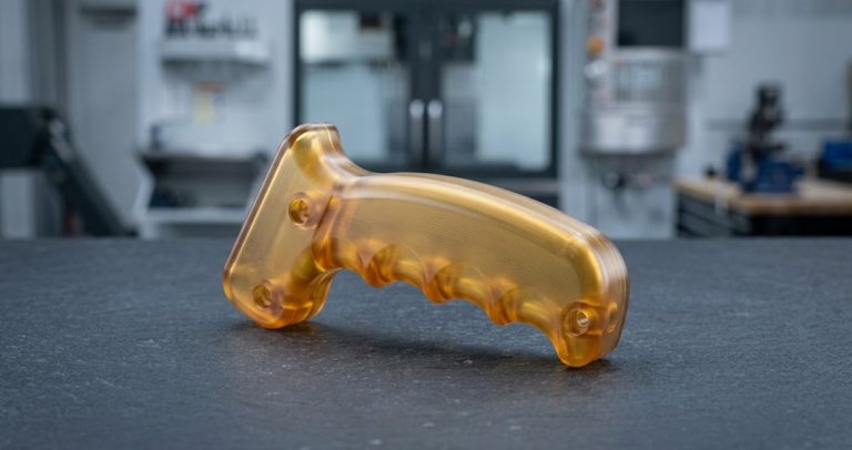 Machined Ultem PEI instrument handle on dark worktable