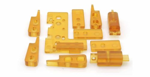Multiple machined PEI plastic parts on white