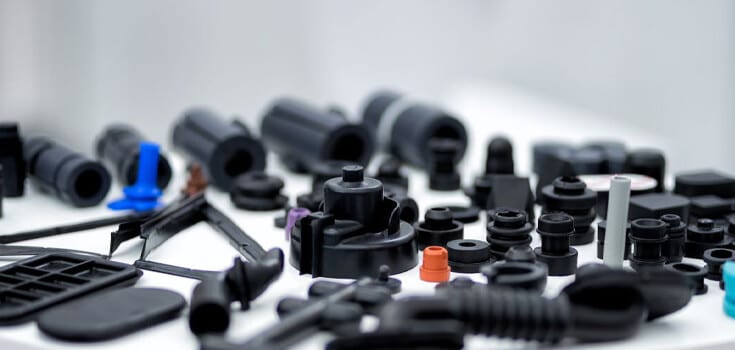 various black plastic automotive components on white background