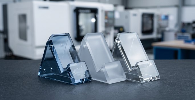 Frosted and mirrored acrylic display stand components on worktable