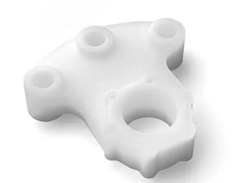 White polyethylene machined part on white background