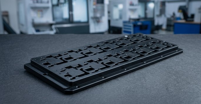 Black POM Delrin plate with machined square cutouts