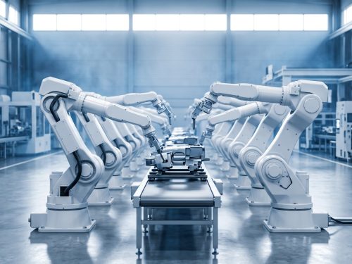 Robotics industry: a line of white six-axis industrial robot arms working on a clean automated assembly line