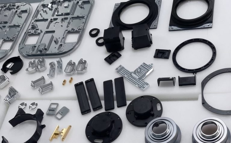 Assorted CNC machined metal and plastic parts laid out