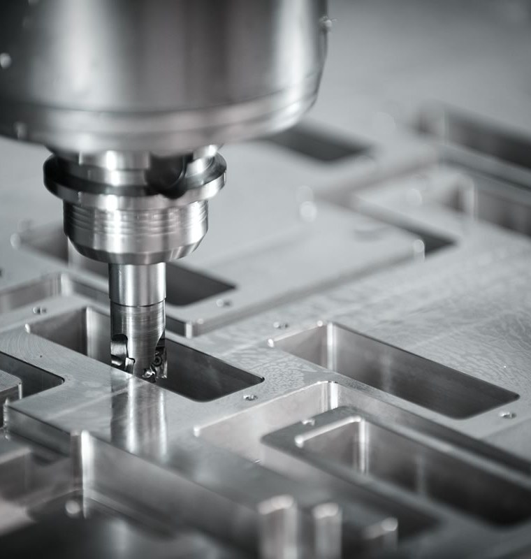 CNC end mill cutting pockets in an aluminum plate