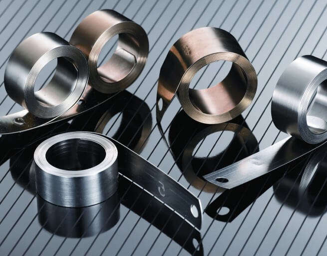 Stainless steel machined rings and brackets on striped surface