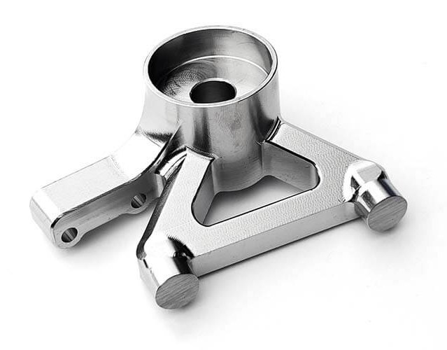 Stainless steel machined bracket on white background