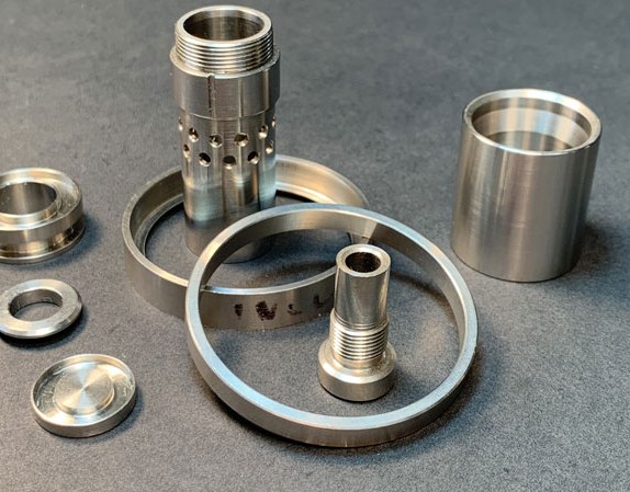 Metal machined parts on gray surface