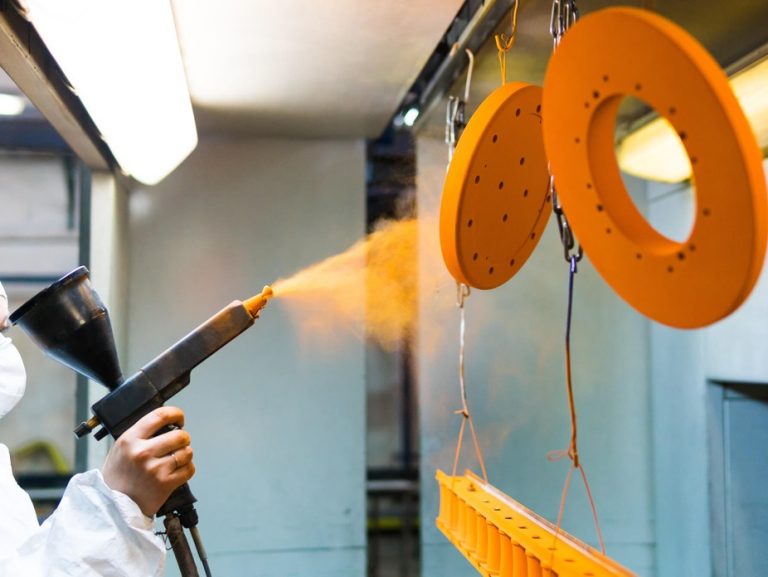 Powder coating a machined part with a spray gun