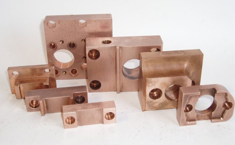Copper CNC machined parts with drilled holes and smooth finish
