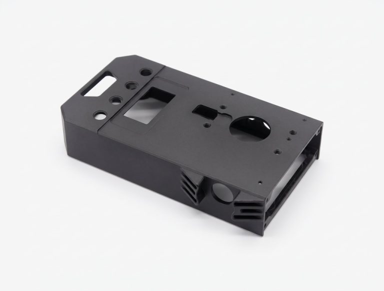 Black machined metal enclosure with cutouts and mounting holes