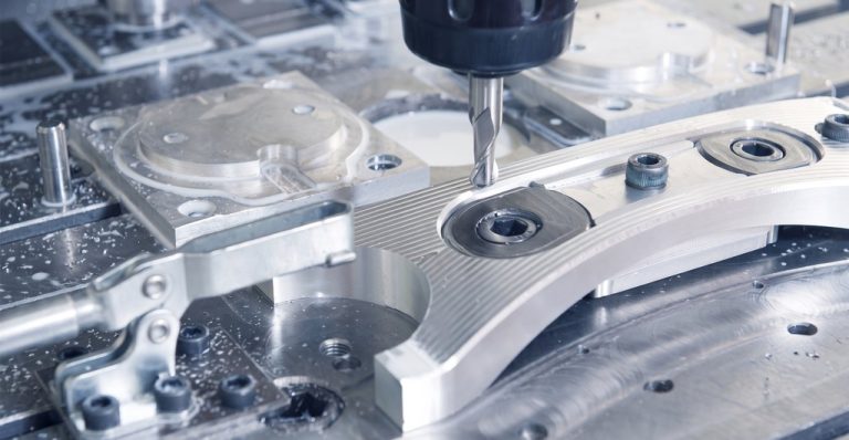 CNC milling tool cutting aluminum part with visible tool marks